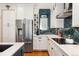 Modern kitchen featuring stainless steel appliances, white cabinetry, and stylish herringbone backsplash at 8189 E 29Th Ave, Denver, CO 80238
