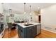 Kitchen island, stainless steel dishwasher and sink, and pendant lighting at 8189 E 29Th Ave, Denver, CO 80238