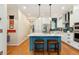 Modern kitchen with a center island, bar stool seating, and stylish finishes at 8189 E 29Th Ave, Denver, CO 80238