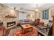 Living room featuring wood floors, fireplace and furniture at 8189 E 29Th Ave, Denver, CO 80238