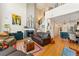 Open-concept living room with fireplace, hardwood floors, and staircase at 8189 E 29Th Ave, Denver, CO 80238