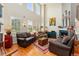Bright living room with tall ceilings, large windows, and a cozy fireplace at 8189 E 29Th Ave, Denver, CO 80238