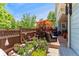 Inviting patio area with stylish outdoor furniture, vibrant plants, and an orange umbrella for shade at 8189 E 29Th Ave, Denver, CO 80238