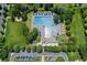 Aerial view of a community pool featuring lap lanes, a diving board, lounge chairs, and shaded areas at 8189 E 29Th Ave, Denver, CO 80238