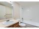 Bathroom with a single sink vanity, toilet, and tiled shower-tub combination at 2225 Buchtel Blvd # 105, Denver, CO 80210