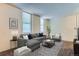 Inviting living room features a comfortable grey sectional sofa, decorative rug, and modern accents at 2225 Buchtel Blvd # 105, Denver, CO 80210