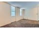 Neutral living room featuring carpet, two windows with blinds, and baseboard radiator at 2225 Buchtel Blvd # 105, Denver, CO 80210