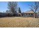 Spacious backyard with a classic brick home and wooden fence at 1654 Valentia St, Denver, CO 80220