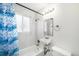 Updated bathroom featuring white tile surround and a new vanity at 1654 Valentia St, Denver, CO 80220