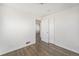 Bedroom with hardwood flooring featuring an open doorway to hall at 1654 Valentia St, Denver, CO 80220