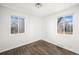 Bright bedroom with hardwood floors, white walls, and windows offering a light-filled space at 1654 Valentia St, Denver, CO 80220
