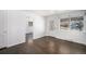 Bright living room with hardwood floors, a large window with natural light and an open doorway at 1654 Valentia St, Denver, CO 80220