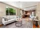 Bright living room features a large window, hardwood floors, and modern furniture at 3925 Pecos St, Denver, CO 80211