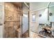 Bathroom featuring a vessel sink, granite countertop, and tiled shower with a built-in bench at 2424 S Jasmine St, Denver, CO 80222
