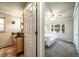 Stylish bathroom featuring elegant vanity with an artistic sink and a glimpse into the serene main bedroom at 2424 S Jasmine St, Denver, CO 80222