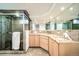Bathroom with granite countertops, double sinks, an oversized mirror, and a glass-enclosed shower at 2424 S Jasmine St, Denver, CO 80222