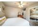 Comfortable bedroom featuring a ceiling fan, closet with mirrored doors, and a serene ambiance for relaxation at 2424 S Jasmine St, Denver, CO 80222