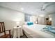 Bedroom featuring a queen sized bed with blue accents, an overhead ceiling fan and bright lighting at 2424 S Jasmine St, Denver, CO 80222