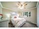 Cozy bedroom with a large window, ceiling fan, and neutral paint at 2424 S Jasmine St, Denver, CO 80222