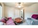 Cozy bedroom features a ceiling fan, closet and a sitting area with a sofa and chair at 2424 S Jasmine St, Denver, CO 80222