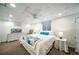 Bright basement bedroom features a queen bed with white linens and colorful accents at 2424 S Jasmine St, Denver, CO 80222