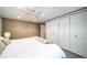 Bright bedroom with a large bed, multiple closets, neutral decor, and natural light at 2424 S Jasmine St, Denver, CO 80222