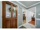 Welcoming entryway with decorative glass front door and view into dining room and living room at 2424 S Jasmine St, Denver, CO 80222