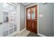 Inviting entryway featuring a decorative glass front door and tiled flooring, creating a warm welcome at 2424 S Jasmine St, Denver, CO 80222