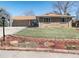 Charming front exterior featuring brick facade, a well-manicured lawn, and a two-car garage at 2424 S Jasmine St, Denver, CO 80222