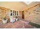 Charming front porch with brick accents, decorative plants, and cozy seating, perfect for relaxing at 2424 S Jasmine St, Denver, CO 80222