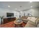 Spacious living room featuring hardwood floors, a comfortable sectional sofa, and plenty of natural light at 2424 S Jasmine St, Denver, CO 80222
