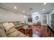 Inviting living room featuring hardwood floors, a cozy fireplace, and comfortable seating at 2424 S Jasmine St, Denver, CO 80222