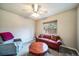 Comfortable living room with a ceiling fan, a cozy sofa, an armchair, and a round wooden coffee table at 2424 S Jasmine St, Denver, CO 80222