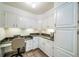A home office featuring white cabinets, granite countertops, and ample storage at 2424 S Jasmine St, Denver, CO 80222