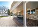 Covered brick patio with a dining table and chairs, featuring a brick exterior and a grassy yard at 2424 S Jasmine St, Denver, CO 80222