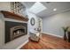 Cozy sitting room boasts a skylight, wood floors, and fireplace for a serene ambiance at 2424 S Jasmine St, Denver, CO 80222