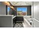 Stylish gray bathroom featuring a soaking tub, modern vanity, and large window offering natural light at 476 S Saulsbury St, Lakewood, CO 80226