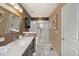 Bathroom featuring a walk-in glass shower, neutral color palette, and quartz countertops at 476 S Saulsbury St, Lakewood, CO 80226