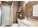 Bathroom featuring shower, toilet, sink, and a mirror at 476 S Saulsbury St, Lakewood, CO 80226