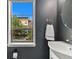 Stylish bathroom with modern fixtures, dark gray walls, and a bright window at 476 S Saulsbury St, Lakewood, CO 80226