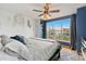 Bright bedroom with a large window, providing ample natural light, and a cozy bed with stylish decor at 476 S Saulsbury St, Lakewood, CO 80226