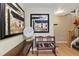 Inviting entryway featuring modern art, wooden bench, and hardwood floors leading to the staircase at 476 S Saulsbury St, Lakewood, CO 80226