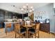 Open-concept kitchen and dining area with a stylish chandelier and coffee bar setup at 476 S Saulsbury St, Lakewood, CO 80226
