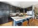Modern kitchen featuring dark cabinets, granite countertops, and stainless steel appliances at 476 S Saulsbury St, Lakewood, CO 80226