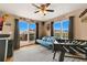 Cozy living room with hardwood floors, a ceiling fan, large windows, and access to an outdoor seating area at 476 S Saulsbury St, Lakewood, CO 80226
