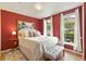 Cozy main bedroom showcasing hardwood floors, bright windows, and warm red walls at 476 S Saulsbury St, Lakewood, CO 80226