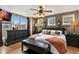 Cozy main bedroom with a large window, dark wood furniture, and stylish lighting, creating a peaceful retreat at 476 S Saulsbury St, Lakewood, CO 80226