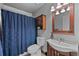 Full bathroom with a vanity sink, and a shower with blue patterned shower curtain at 1150 Inca St # 25, Denver, CO 80204