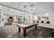 A spacious game room featuring a billiards table, fireplace, and a kitchen with barstool seating at 1150 Inca St # 25, Denver, CO 80204