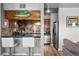 Cozy kitchen with breakfast bar, stainless steel appliances, and unique decorative fish art at 1150 Inca St # 25, Denver, CO 80204